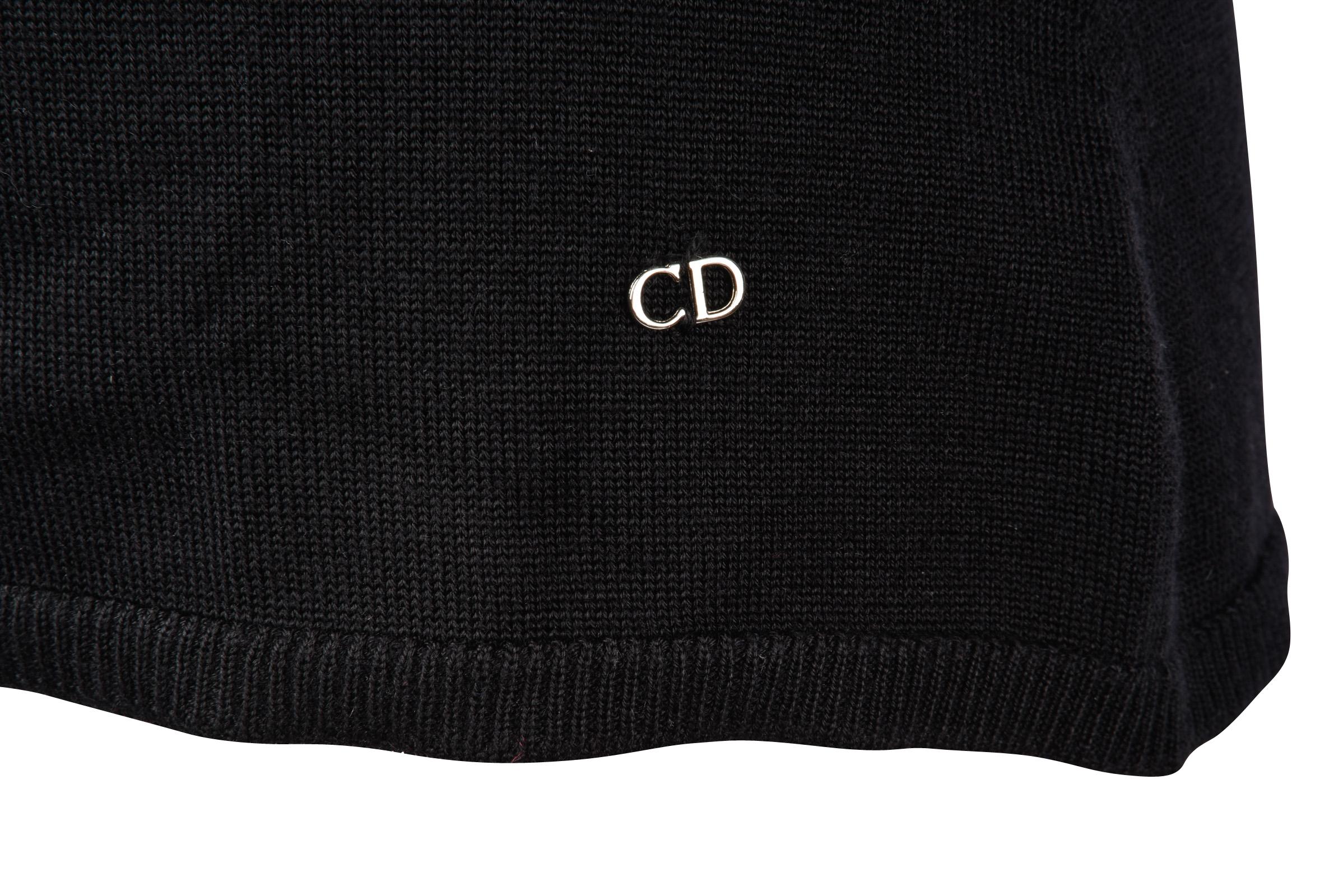 Guaranteed authentic Christian Dior black 3/4 length sleeve cashmere top. 
Scalloped V-neck 
Silver logo plaque bottom left.
Top is pullover. 
Fabric is cashmere and silk.
final sale

SIZE  8

TOP MEASURES: 
LENGTH  24