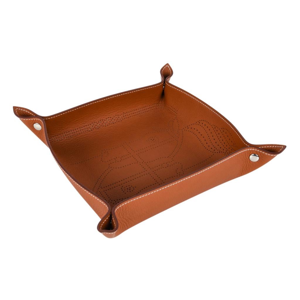 Guaranteed authentic Hermes marvelous Fauve Taurillon leather change tray.
Quadrige micro perforated pattern with a silver snap on each corner.
Accentuated with bone top stitch.
Wonderful for desk or gifting.
New with Hermes box and ribbon.
Final