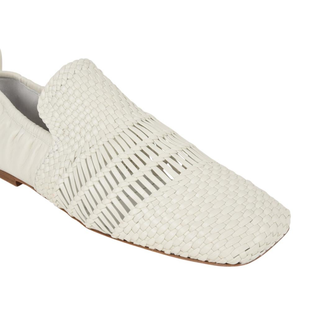 Guaranteed authentic Celine white woven leather flat shoe. 
 Squared to with solid leather at rear of foot.
 Rear tab.
Elastic edge around rear of shoe.     
NEW or NEVER WORN
final sale

  
SIZE  38.5
USA SIZE  8.5
    
SHOE  MEASURES:
HEEL 