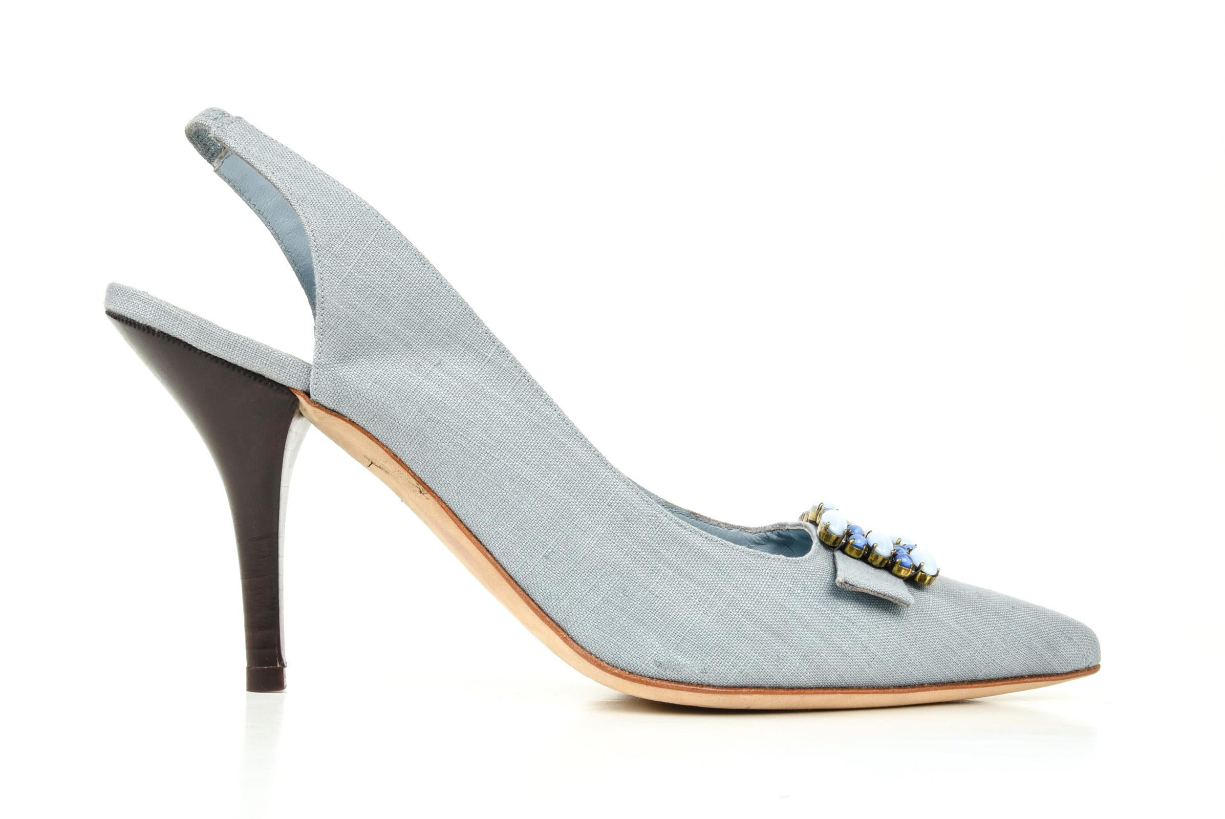 Guaranteed authentic Manolo Blahnik light blue textile slingback shoe.
Medium and light blue beaded buckle over toe.
Stacked dark brown heel and pointed toe.
Comes with sleeper.
final sale
              
SIZE  40.5
USA SIZE 10.5    

SHOE 