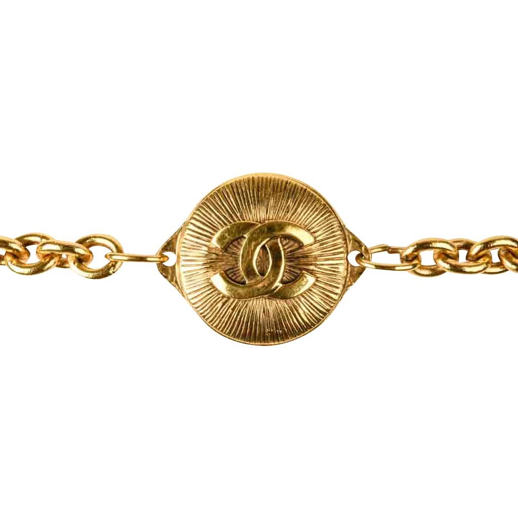 Guaranteed authentic Chanel vintage chain link belt.
Seven (7) round gold Sunburst with center CC logo spacers. 
Each link allows belt to be adjusted.   
Smaller CC charm hangs down. 
Metal logo plaque Chanel Made in France 
final sale
  
BELT