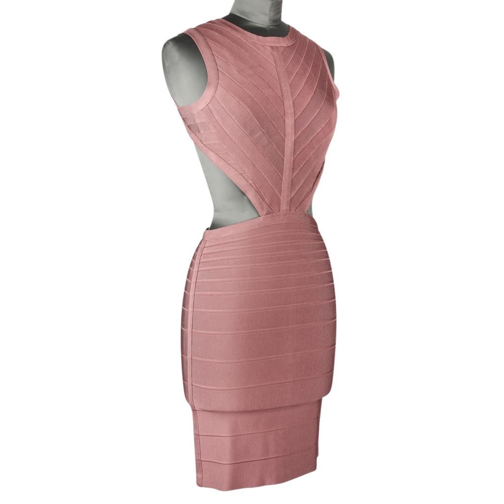 Guaranteed authentic Herve Leger iconic body concious bandage dress with cutouts.
The sides and back are cut out.
Dress is sleeveless with rounded neck line.
Rear has hidden zip and embossed clasp at neck.
No fabric tag.
NEW or NEVER WORN
Final