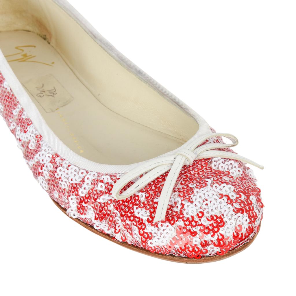 Giuseppe Zanotti ballet flat encrusted with red and white sequins. 
The pailletes create an abstract design making the shoe appear light and airy. 
The shoes have a white grosgrain trim around the top and a white leather bow at the toe. 
The perfect