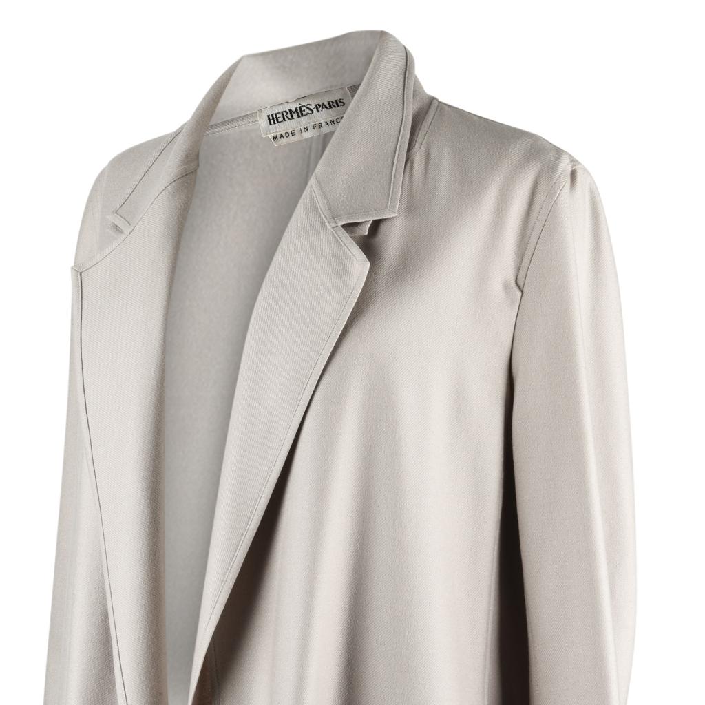 Guaranteed authentic coveted Hermes whisper light cashmere 2 piece coat.
This exquisite putty grey colour set can be worn separately.
The bottom layer is a sleeveless vest with 2 patch pockets.
The top layer is a coat with slits to access the