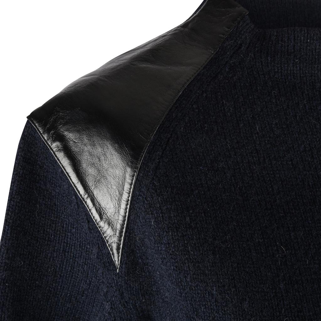 Guaranteed authentic Celine navy blue crew neck sweater with black lambskin shoulders.
3/4 length sleeves. 
Ribbing at neck, cuff and hip. 
Fabric is merino and yak wool.
  
SIZE  M

TOP MEASURES: 
LENGTH 21