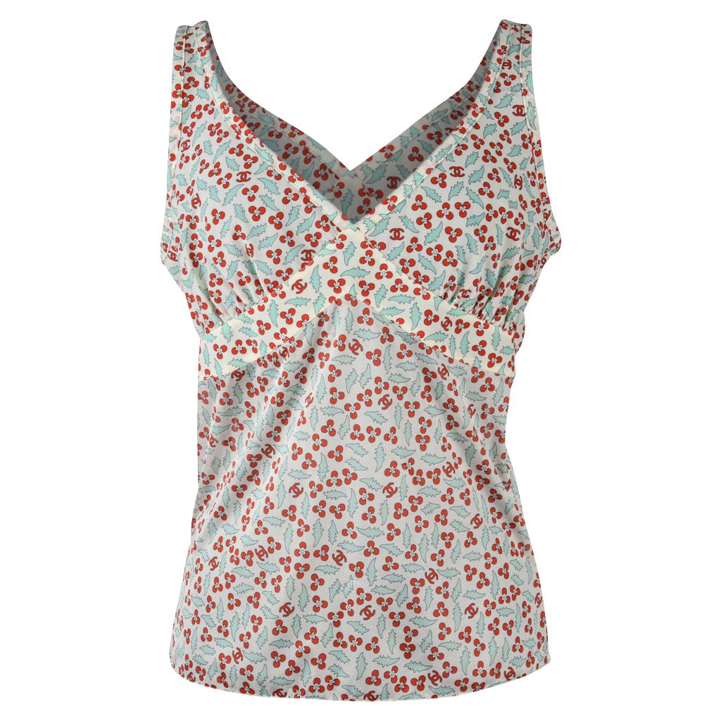 Mightychic offer a Chanel 04P delightful top in pale green leaves and red Cherries with CC throughout. 
Some stretch in a feather light top covered in small red flowers.
V neck with detail under the bust and around the back. Please see detailed