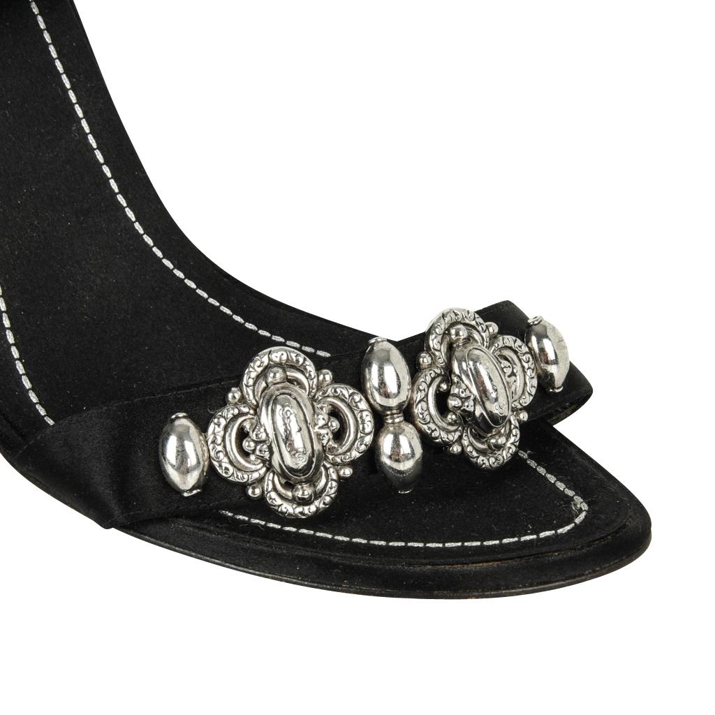 Guaranteed authentic Rene Caovilla black peau de soie shoe.
Black peau de soie open toe closed heel shoe. 
Thin black lacquered - very sexy!
Silver decorative detail on front of shoe . 
Black velvet ankle tie with silver bead tips. 
final sale

SIZE