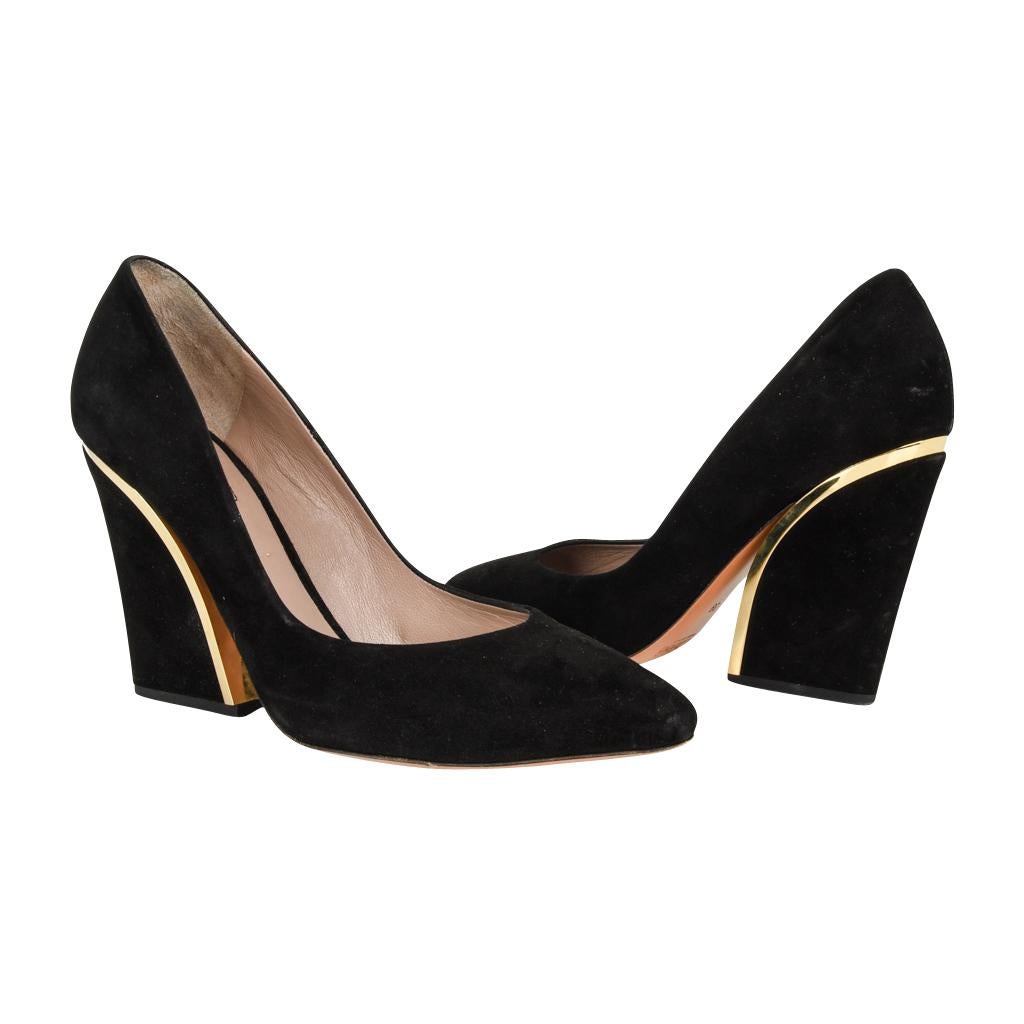 Guaranteed authentic Chloe beautifully detailed block heel pump. 
Black suede shoe gold trim detail around the heel.
Very striking and rich. 
Gently rounded pointed toe.
Versatile and wearable.
Minor natural wear marks.

SIZE 39
USA SIZE 9

SHOE