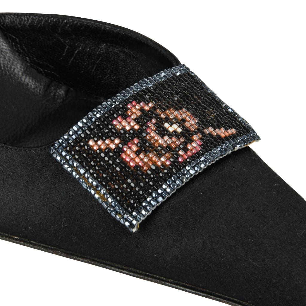 Guaranteed authentic Christian Dior black satin D'Orsay shoe with a beautiful beaded flower.
Edged in gunmetal beads with the center in black. The flower is a dusty pink. Divine effect!
Beautiful shaped heel, and the heel of the foot. 
Beading