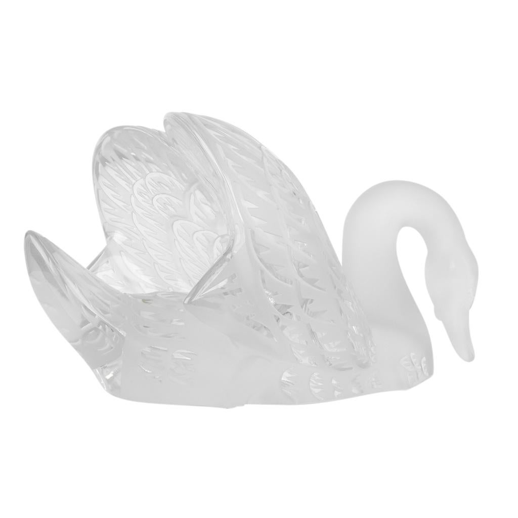 Mightychic offers a Lalique pure crystal satin finish coveted Swan Head Down sculpture. 
First designed in 1943 by Rene Lalique this ethereal swan is depicted gliding with her wings back and head bowed and neck bent. 
Hand crafted in France.
This