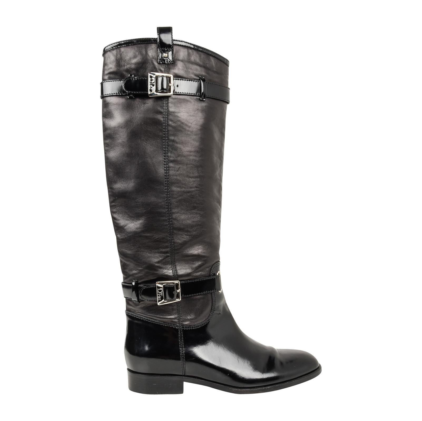 Guaranteed authentic Christian Dior black leather flat boot with straps around ankle and calf.
Riding style boots have smooth box calf on foot and straps and leather on calf.
Strap hardware is logo embossed. 
Boot pulls on. 
Minor natural wear