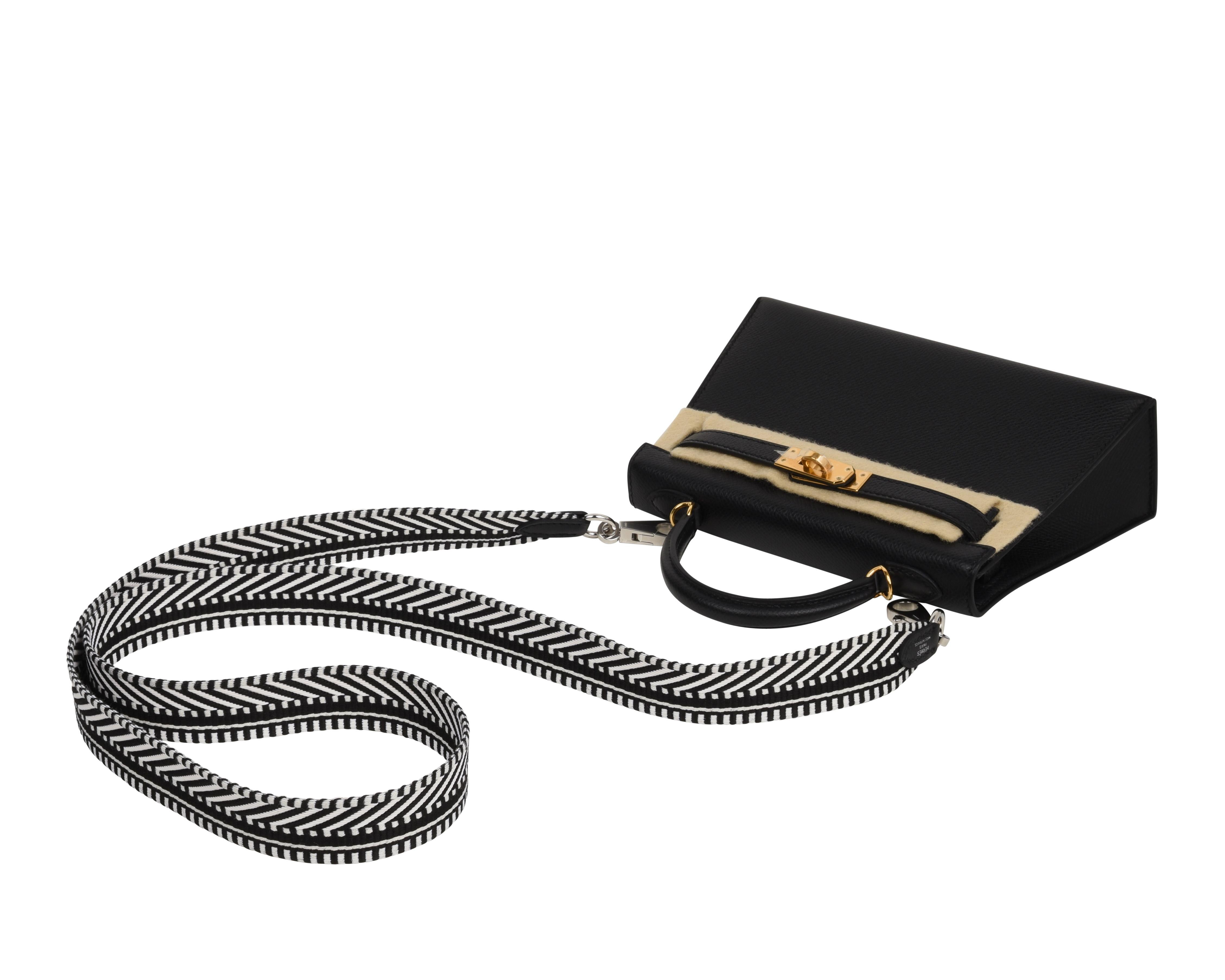 Guaranteed authentic Sangle Cavale 25 MM black and ecru white bag strap. 
Swift calfskin and Palladium hardware.
Is compatible with a myriad of Hermes Handbags for added fun and flare!
Accompanied by sleeper, signature Hermes box and ribbon.
New or