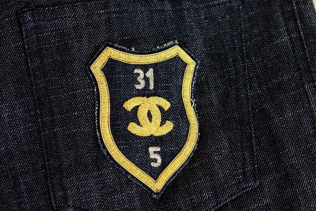 Guaranteed authentic CHANEL 05C dark blue denim jeans. 
Mid rise waisted straight leg. 
Awesome embroidered signature rear pocket patch.
CC embossed silver button.
Fabric is cotton and spandex.
more pictures available upon request
final