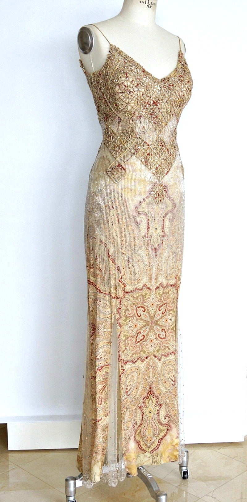 Stunning spaghetti strap extremely embellished gown.
Subtle paisley print in creams, soft gold, burgundy and black.
The top and waist area is created by rolled silk fabric with intricate lattice like effect.
Small diamantes accentuate the cut out