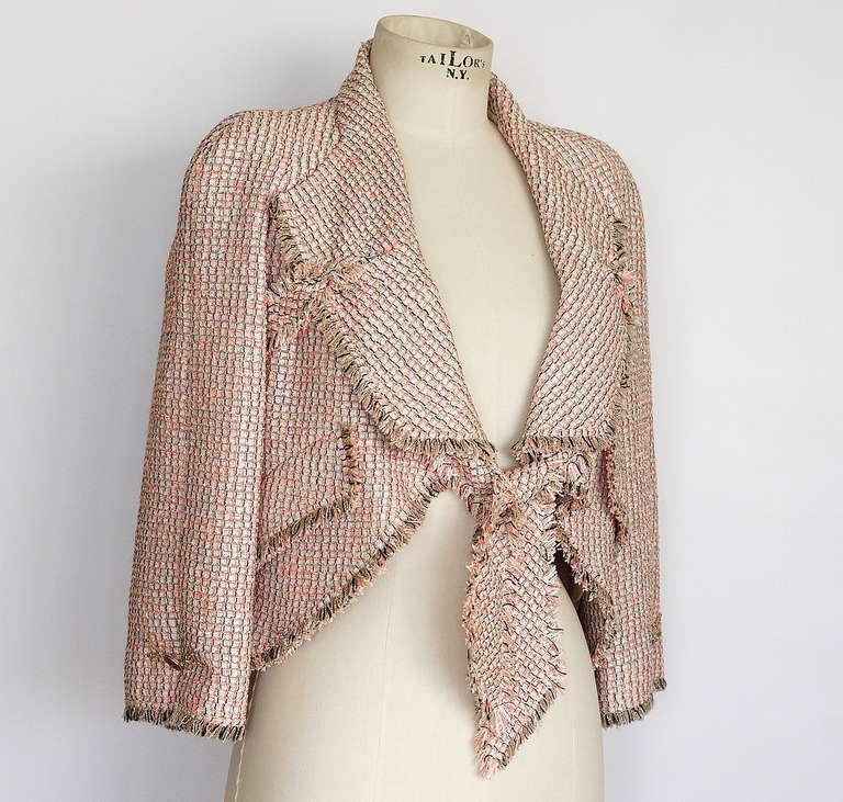 Guaranteed authentic CHANEL 11P divine short tie front swing jacket.
Exquisite pinky tweed with gray white and taupe ribbon tie front jacket.
Tie extends from the back of the jacket through and under the lapels to elegantly fall or be tied in