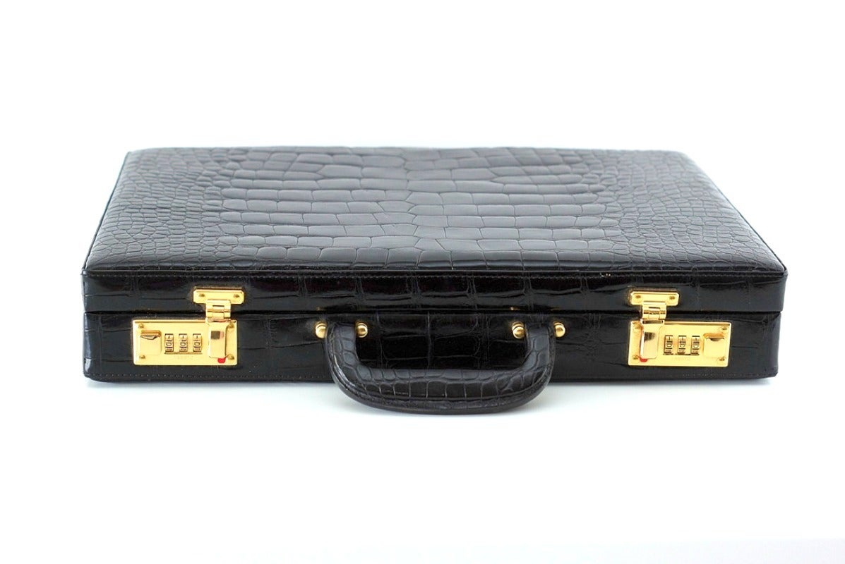 Absolutely gorgeous vintage crocodile briefcase.
Beautiful scales. 
Interior is lined in olive green pigskin.
Brass hardware. 
Interior has 3 large back pockets with several smaller sections to hold business cards, additional documents and