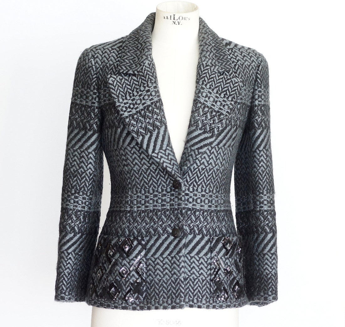 Guaranteed authentic CHANEL 00A coveted black and gray tweed jacket and companion scarf. 
Beautiful 2 button single breast black and gray tweed jacket.
2 patch pockets with black and silvery gray sequin detail.
All buttons are black with diamante