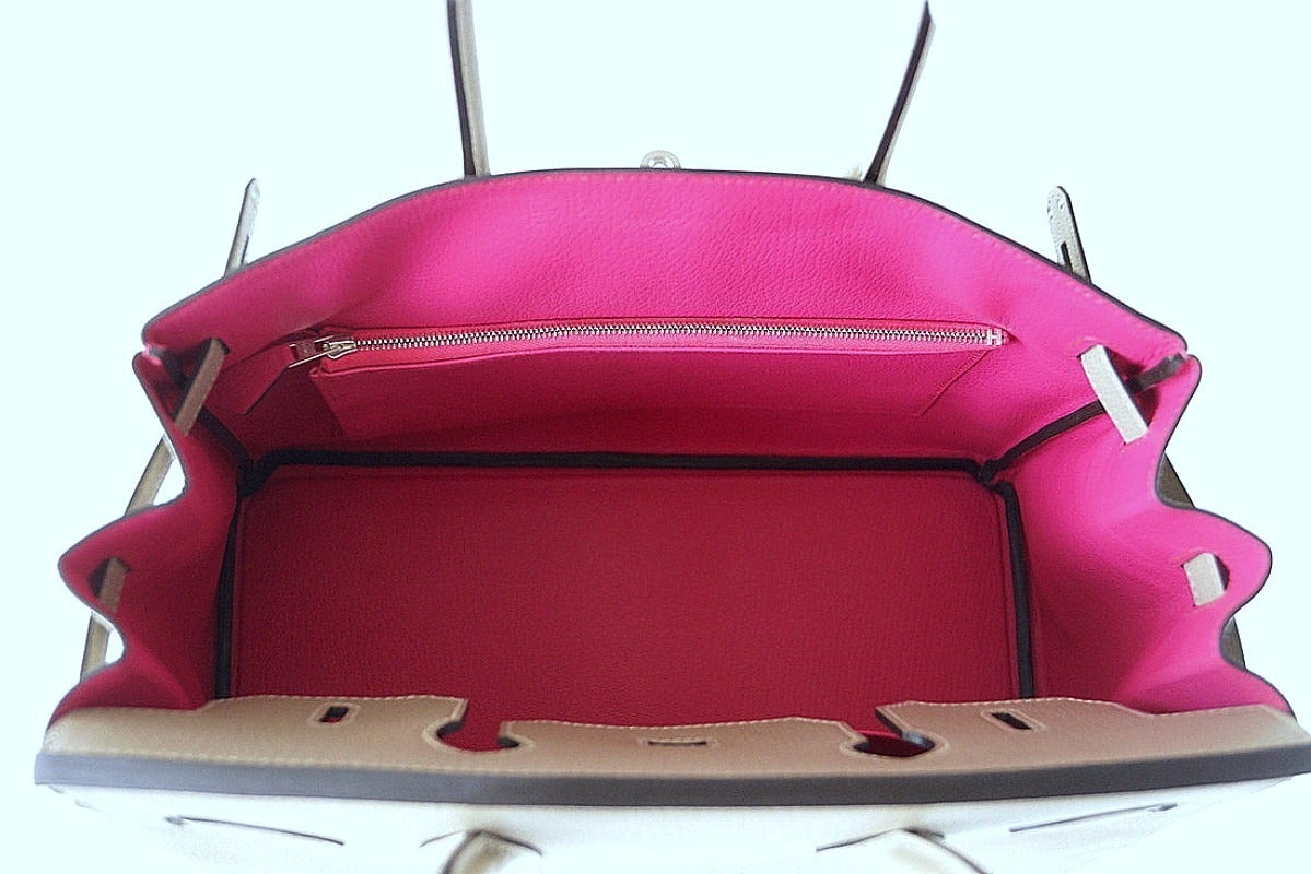 Special Order Horseshoe with unique details.
Gris Tortourelle in Chevre with brushed palladium hardware. 
Coveted Rose Shocking interior.  
Pockets are reversed - rear has slot with cell phone pocket.
Front interior has zipper pocket.
Comes