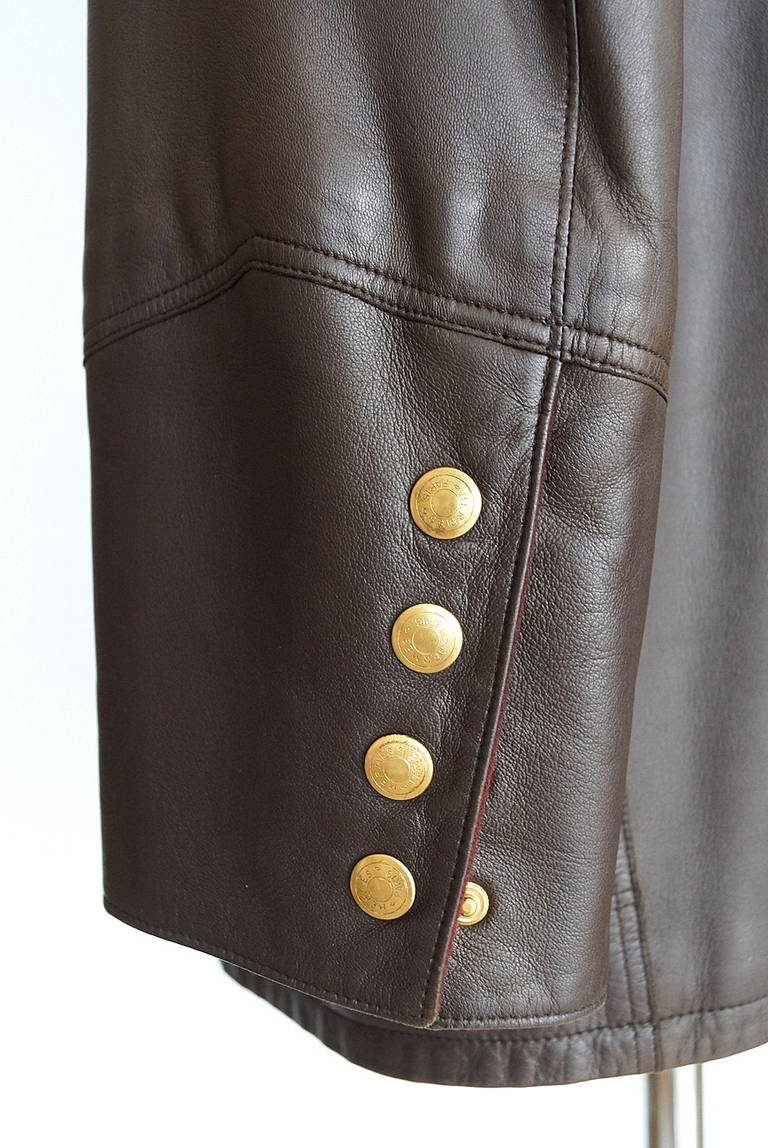 Mightychic offers a vintage Hermes jacket featured in chocolate brown lambskin leather.
The sleeves have five working gold clou de selle snaps at the cuff.  
The sleeves are sensational as they give the effect of a subtle widening at the cuff