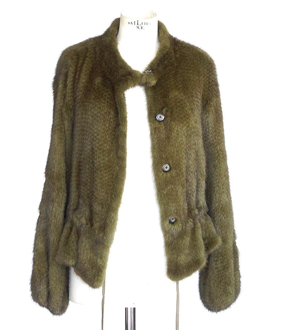 Guaranteed authentic ROBERTO CAVALLI mink Mustela Vison drawstring jacket in lush moss green. 
Farmed raised mink is dense lightweight fur.
Lustrous in rich moss green, the interior is leather trimmed for the drawstring.
Silver logo embossed