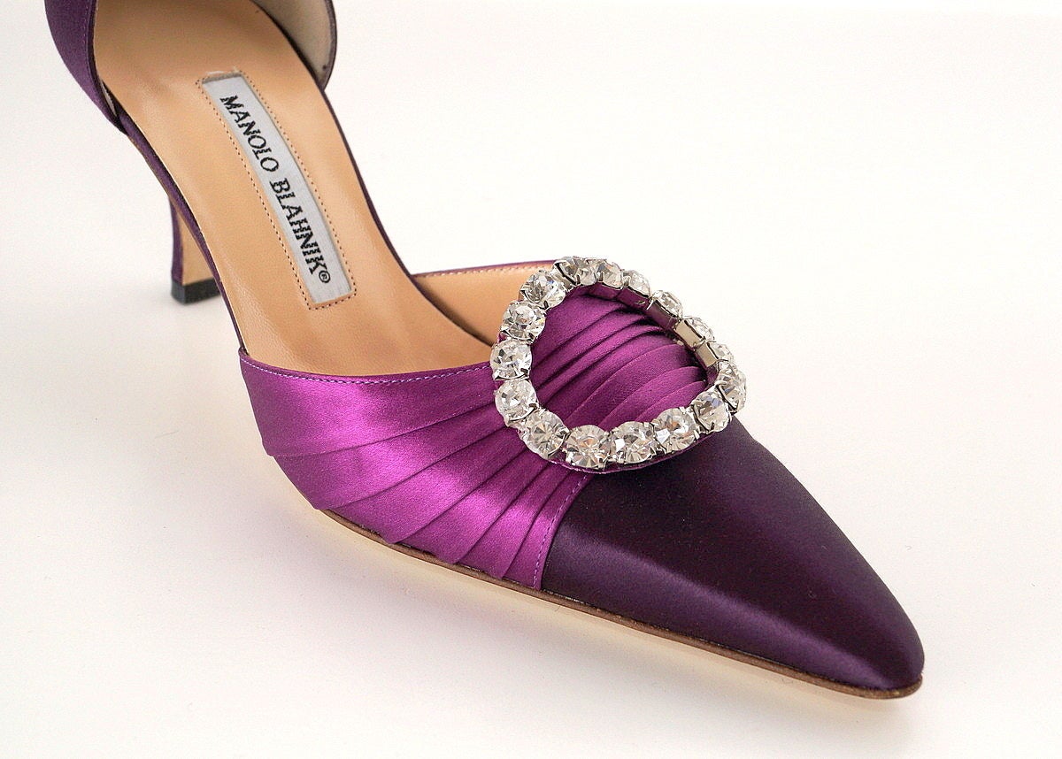 Guaranteed authentic terrific MANOLO BLAHNIK  D'Orsay jeweled pump.
Rich dark magenta satin heel and toe.
Lighter magenta pleated satin across foot with large diamante 'pin'. 
Fabulous!
NEW or NEVER WORN. 
Comes with box and sleepers.   
More