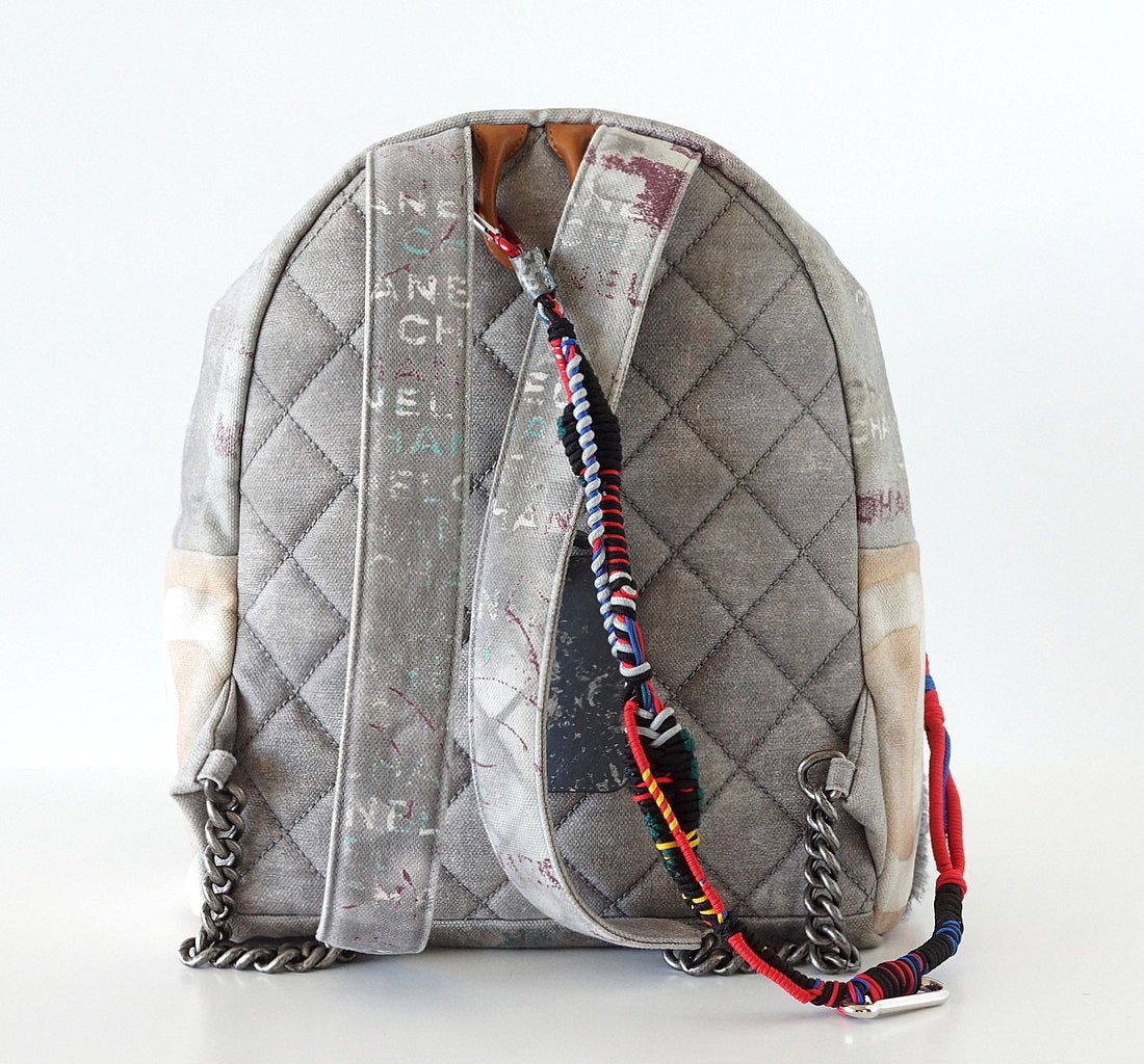 Guaranteed authentic Limited Edition 2014 Spring/Summer gray Graffiti.
A Celeb fav!
Sold out Collectors item rare to find New.
All are unique with signature quilting, colourful rope, CC, distressed luggage tag and braided zip pull.
Adjustable