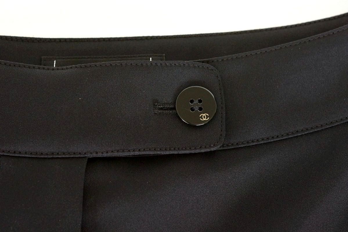 Guaranteed authentic CHANEL 01A chic slim black pant. 
Superbly cut black classic front narrow leg pant.
Front zip with a black button embossed with a small gold CC.
1 rear slit pocket with hidden button.
Fabric is silk and elastane.
NEW OR