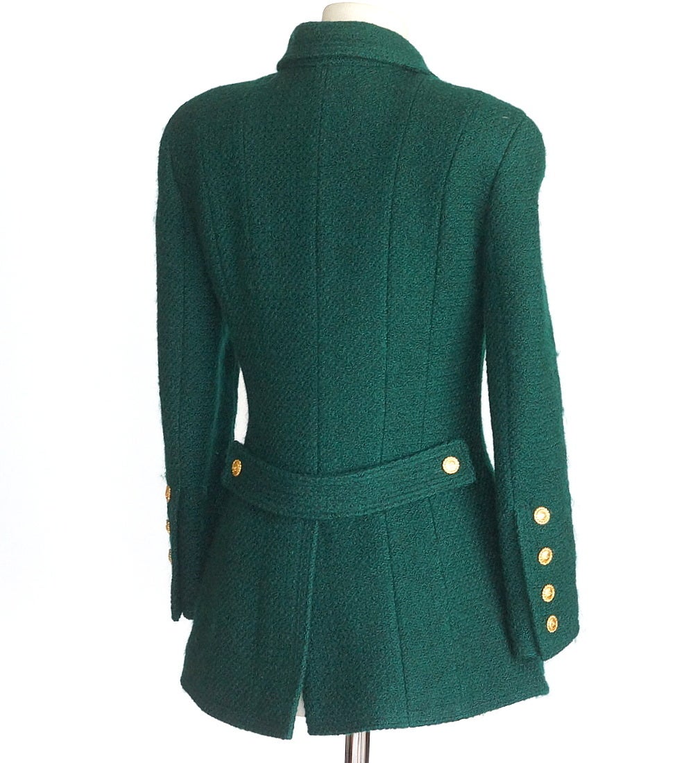 Guaranteed authentic Chanel exquisitely shaped vintage rich racing green jacket.
Double breast with 12 gold logo embossed buttons.
2 flap pockets with gold embossed button.
Each cuff has 4 working buttons.     
Tab at rear is secured with 2 working