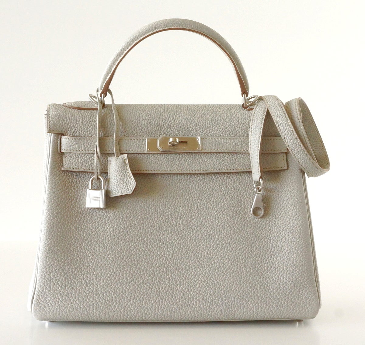 32 cm Hermes Kelly Retourne Special Order Horse Shoe with rare brushed palladium hardware.
Gris Perle with Gris Tourterelle interior creates a chic and sophisticated 
NEW or NEVER WORN.
Comes with signature HERMES box, raincoat, shoulder strap,
