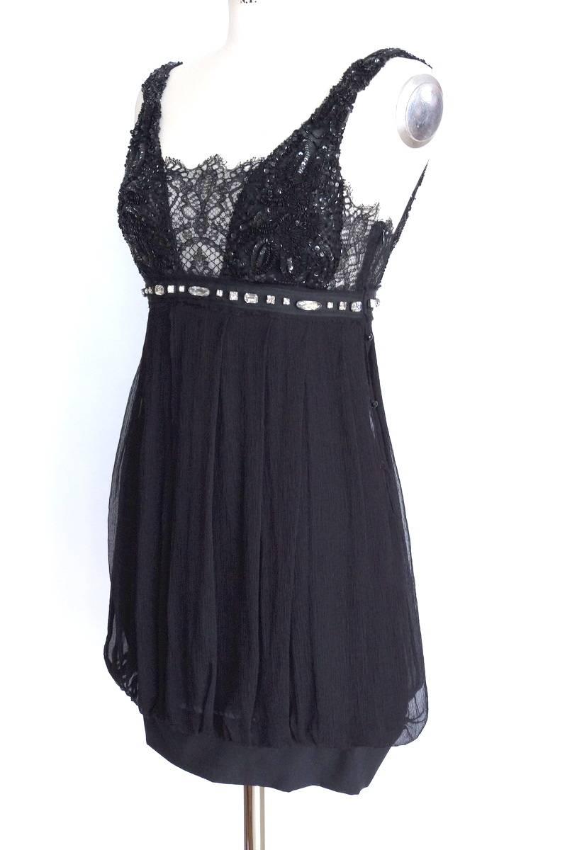 Guaranteed authentic Collette Dinnigan black empire waist jeweled deep V neck dress.
Exquisite lace inserts around the top.
The bust area front and rear is adorned with sublime black bead and sequin work in a floral pattern.
The straps are encrusted