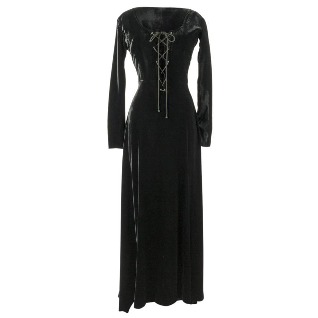 Mightychic offers a vintage Hermes jet black Velvet long dress that is over the top sensational. 
Deep wide cut scoop neck.
The front of the dress laces up to the waist! 
The dress has a beautiful drape and the rear has a center fall that is longer.
