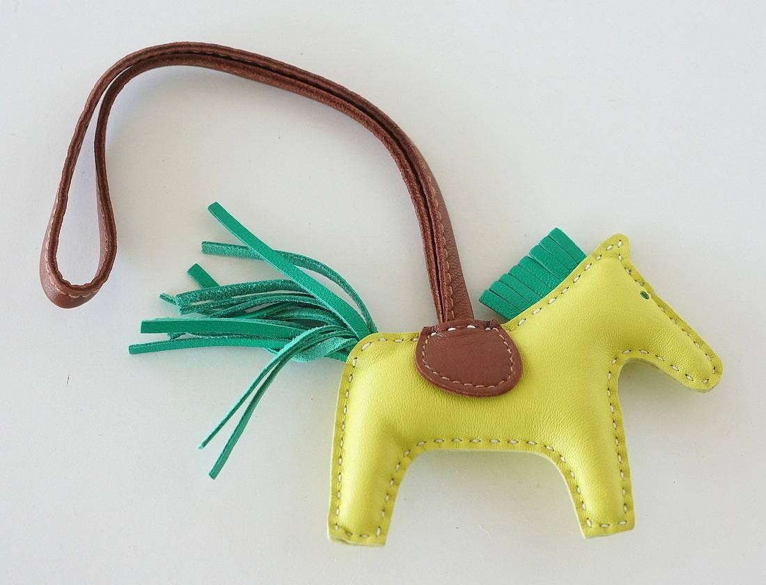 Chic mini pm Lime rodeo horse charm with Menthe tail and mane.
Saddle and holder are Fauve.
Skin is lamb Milo.  
Signature HERMES PARIS MADE IN FRANCE is stamped under saddle.
Comes with signature Hermes box. 