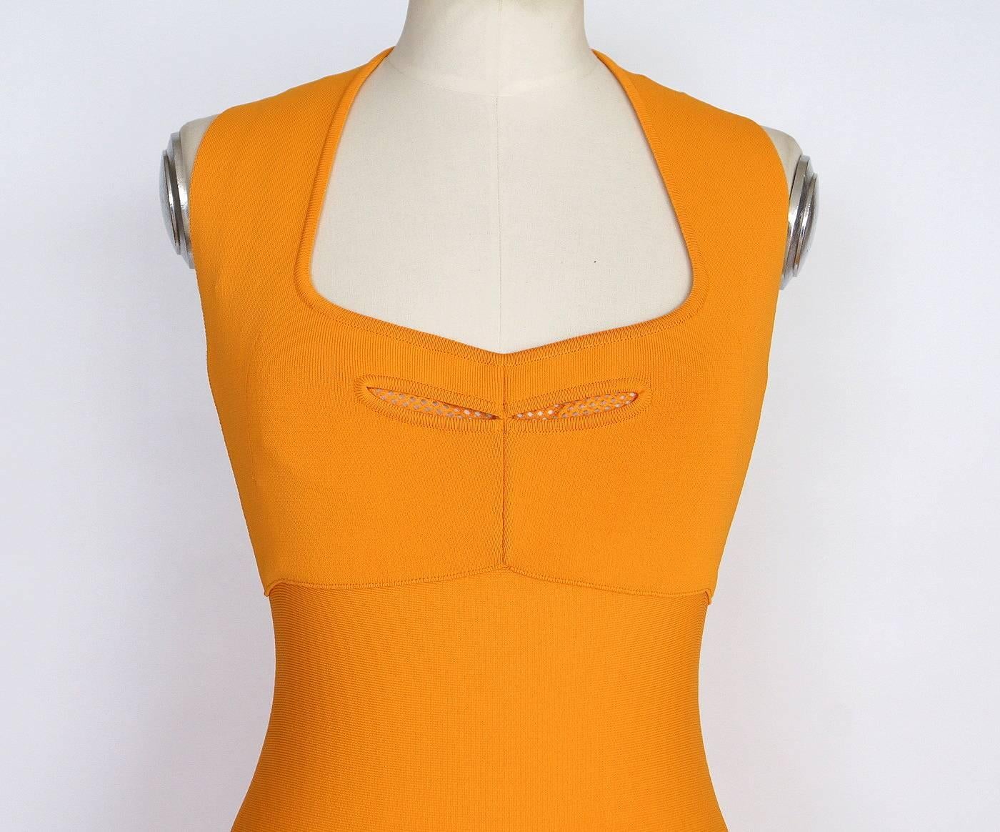 Guaranteed authentic ROLAND MOURET beautifully styled butterscotch dress 
with exceptional style and cut.
Beautifully shaped squared neckline in front with scuba net peek a boo.
Stitching detail under bust line.
Bold rear zipper runs the length of