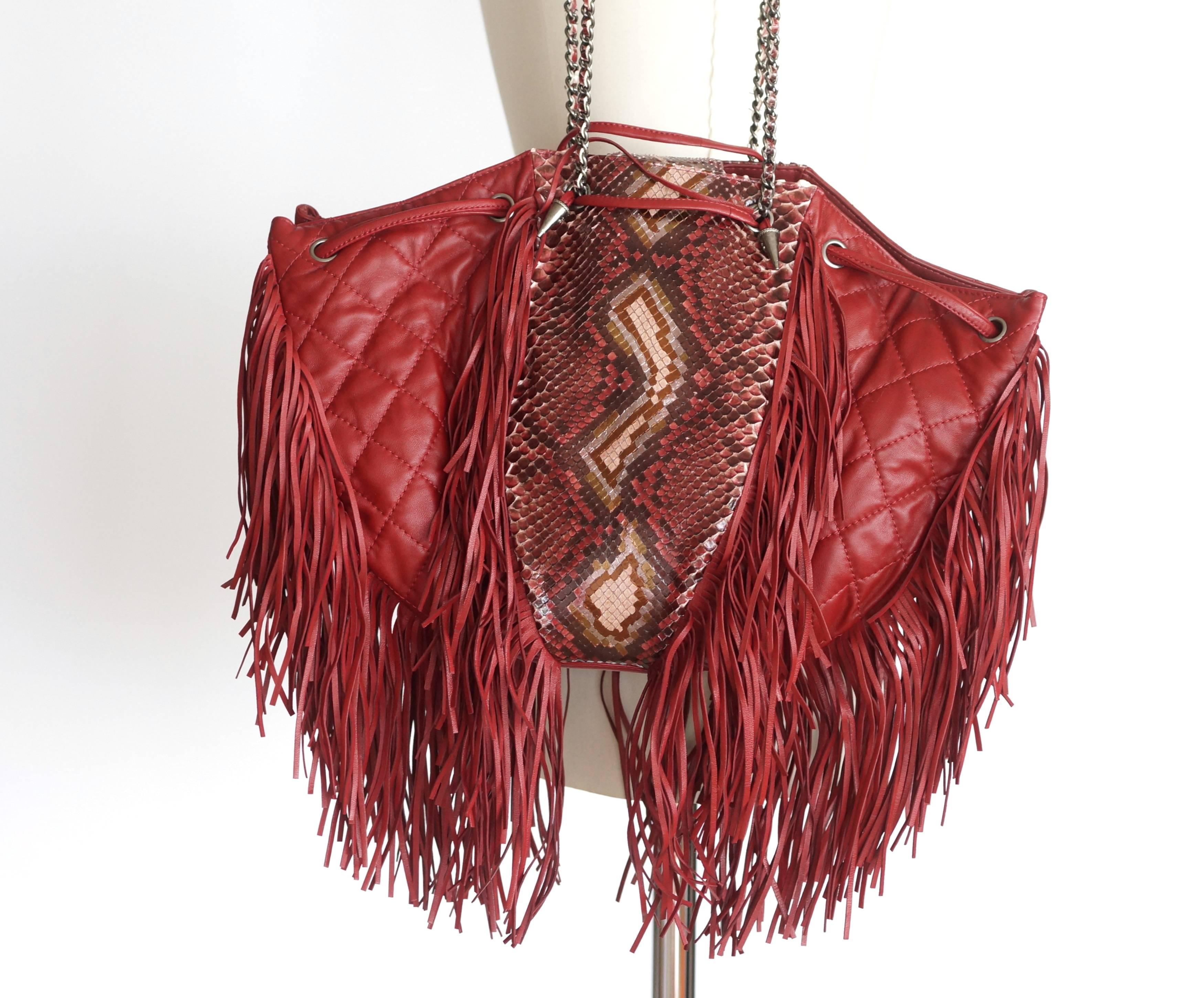 Guaranteed authentic Chanel Dallas Collection Drawstring Fringe shoulder bag with signature chain link shoulder straps.
Presented in the brand's Paris-Dallas Metiers d'Art 2013-2014 Collection it brings a flair of Americana.
Quilted in claret red