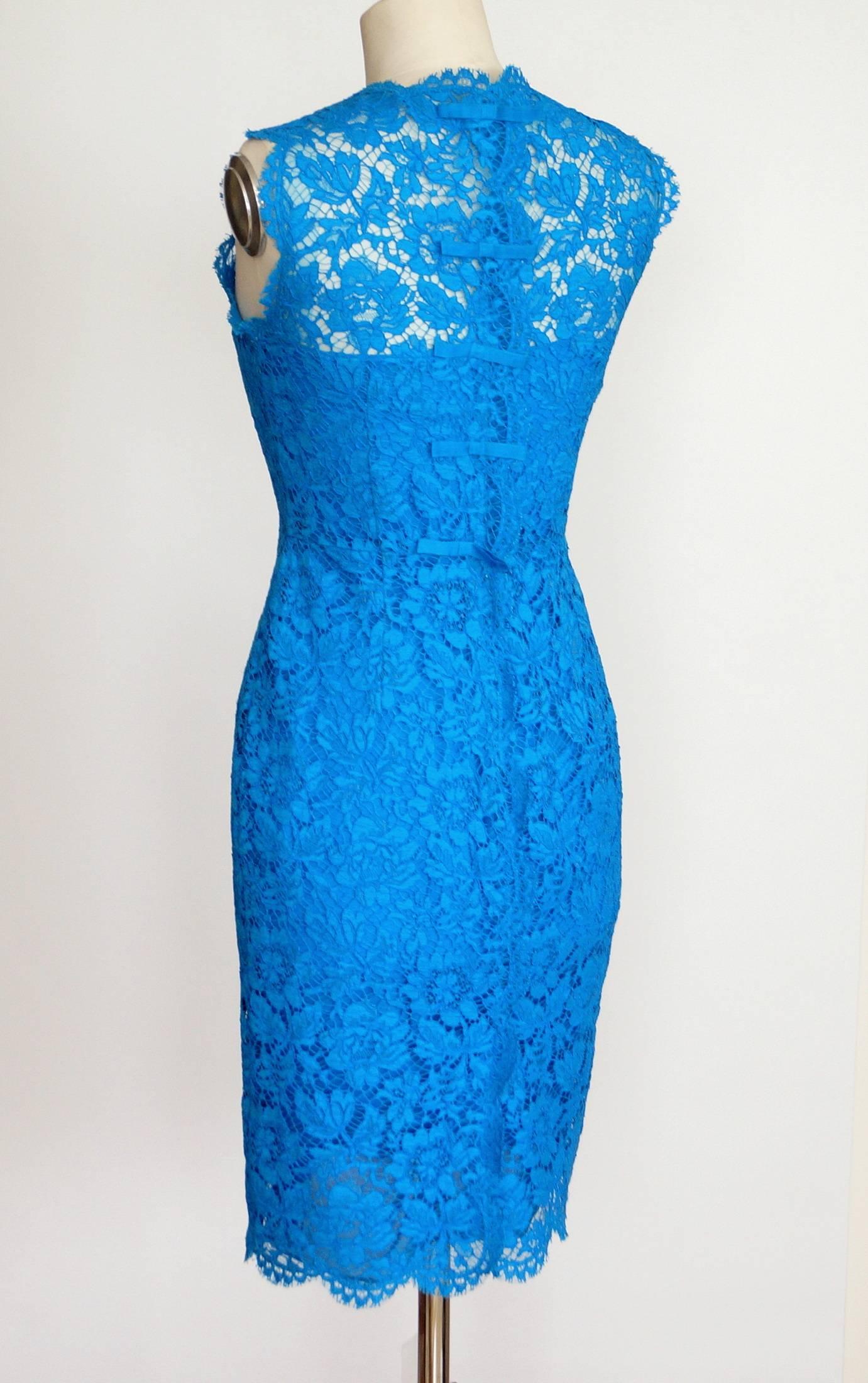 Guaranteed authentic VALENTINO signature lace dress with rear bows. 
Vivid blue lace dress with lovely scalloped edging.
First 2 bows have hidden buttons with the last 3 covering the zipper.
Dress is fully lined.
NEW or NEVER WORN.  Tag