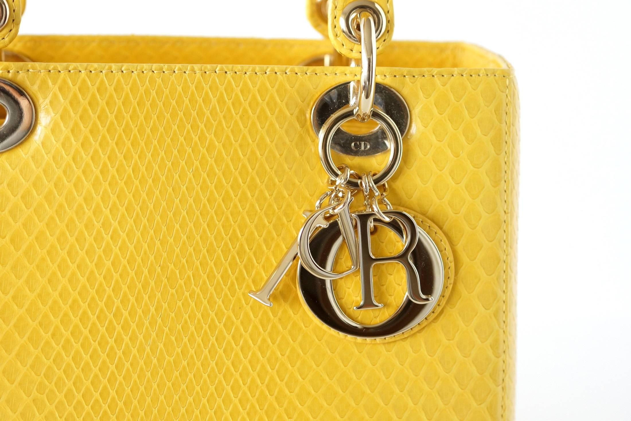 CHRISTIAN DIOR Lady Dior mittelschöne klare gelbe Schlangenhaut. 
Verdeckter Reißverschluss oben. 
Signatur-Logo-Charme. 
Innen ist eine Reißverschlusstasche. 
Signatur-Lederplakette innen. 
Inklusive Schultergurt:: Schläfer:: Box und allen