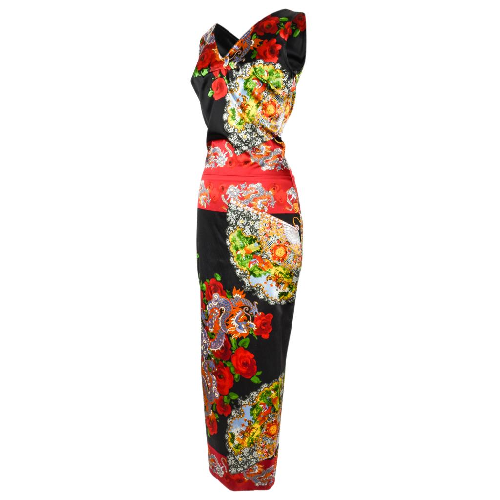 Guaranteed authentic exquisite Dolce&Gabbana Collectors dress featured in rich bold dragon and fan Asian inspired print.
Flattering fitted dress with rear waist accentuated in soft inverted pleating detail. 
Jet black with vivid red, greens, soft