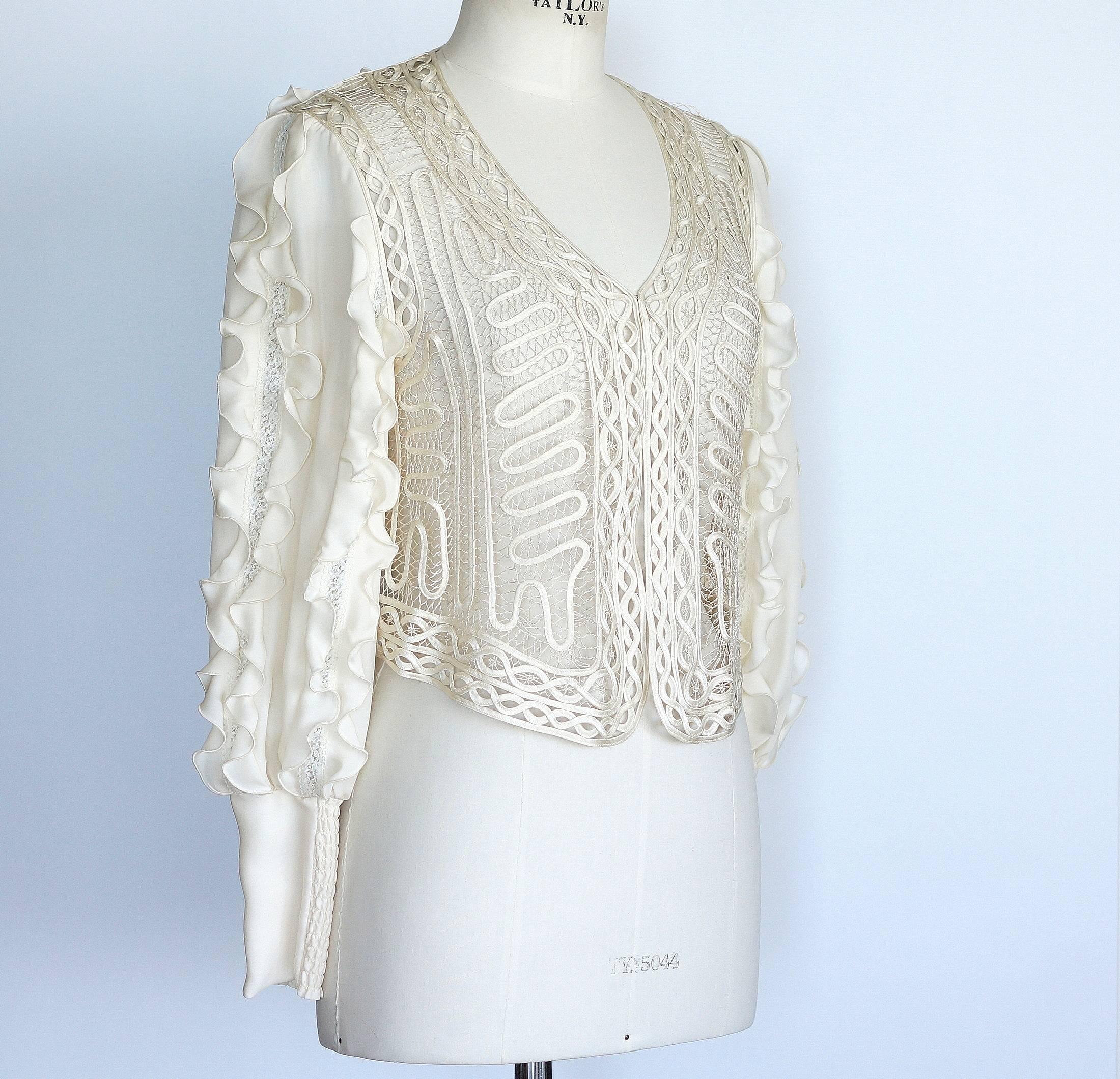 Guaranteed authentic HAUTE HIPPIE cream long sleeve V-neck detailed top.   
Vertical ruffles on sleeves with lace insets.
Front has soutache on open netting background.
Rear has 3 rows of vertical ruffles with lace insets.
Fabric is silk.
NEW or