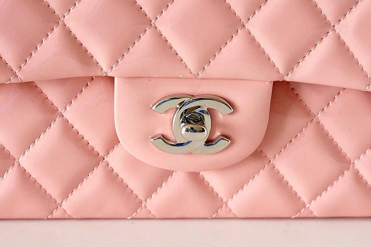 Absolutely fabulous Chanel 2013 medium flap bag in perfect French pink patent leather! 
Silver CC turnkey. 
Silver link chain strap can also be doubled and hand held.
Rear exterior slot pocket. 
Interior slot pocket and zipper pocket with silver CC