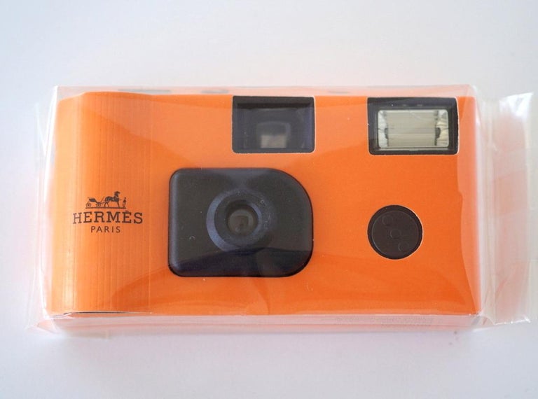 Guaranteed authentic Hermes disposable camera. 
Disposable camera in classic Hermes orange.
The camera was produced in 2001 as a Limited Edition VIP gift item.
Comes with box.
NEW or NEVER USED

CAMERA MEASURES:
LENGTH  4 3/8