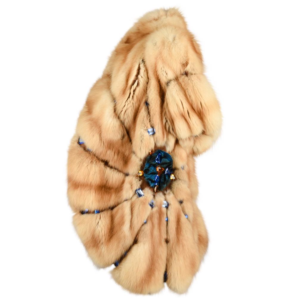 Guaranteed authentic Russian sable fur car jacket style in warm honeyed tones.  
Beautiful faceted glass stones in blue and amber in various shapes and sizes.
A fur appliques set with large stones on each side of waist.
2 pockets and 1 hidden hook