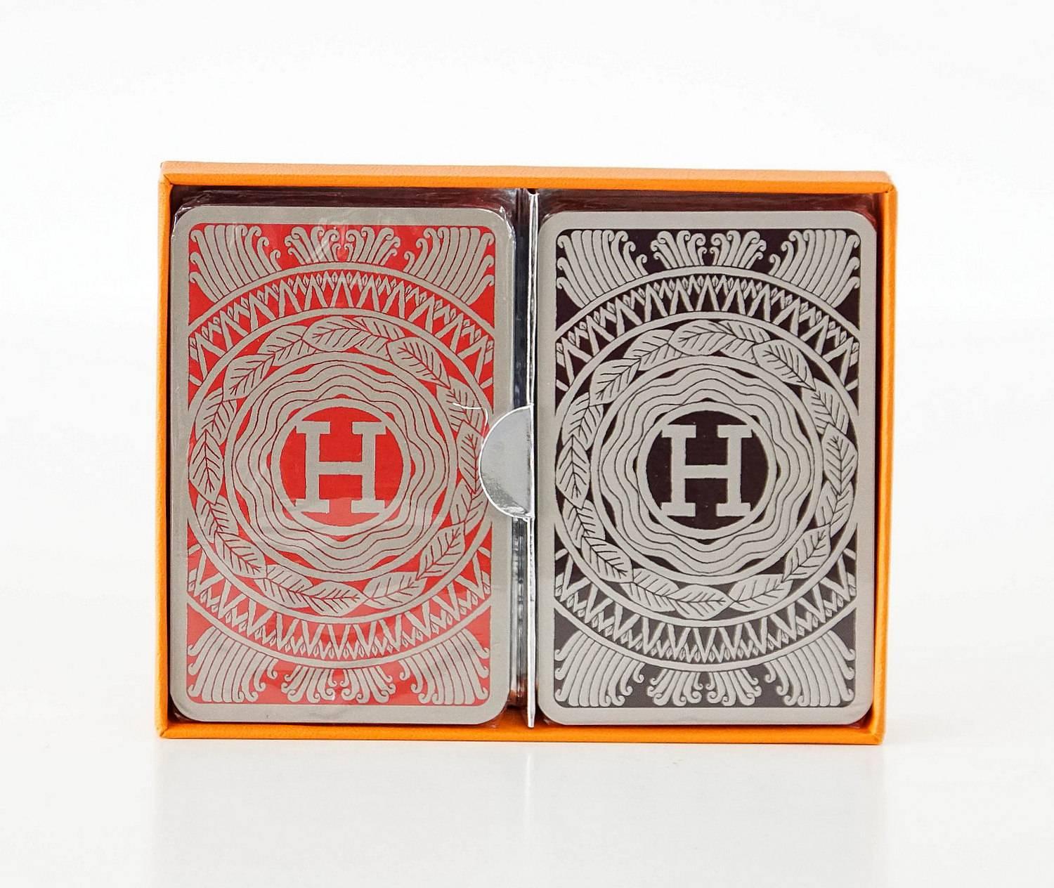 Guaranteed authentic HERMES playing cards - marvelous gift idea!
2 sets of playing cards.
1 set is red and gray the other is black and gray.
Trim color is silver.
The cards are new and sealed.
Comes with signature HERMES box.
more pictures