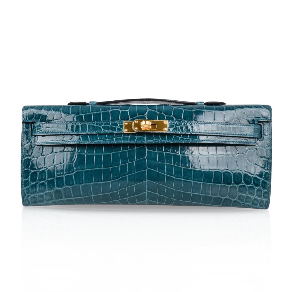 Mightychic offers a timeless Hermes Kelly Cut featured in smoky Bleu Colvert Niloticus Crocodile.
Lush with Gold hardware.
The perfect pop of soft colour for any outfit.   
Stamped HERMES MADE IN PARIS on the interior. 
Comes with sleeper and