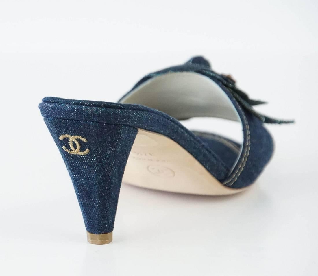 Guaranteed authentic fabulous CHANEL denim mule.
Dark wash blue jean mule with camelia at the front and embossed grommet.
Embroidered CC on heel.
Shaped covered heel. 
NEW or NEVER WORN.
more pictures available upon request 
final sale
