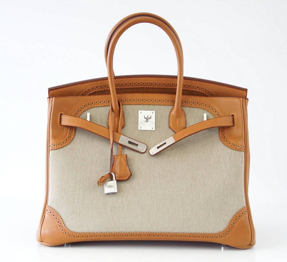 Guaranteed authentic beautifully detailed Hermes Ghillies Birkin in Barenia leather and Toile with contrasting orange stitching.
Rare brushed Palladium hardware.
Comes with sleeper, raincoat, lock and keys.
final sale

BAG MEASURES:
LENGTH  35 cm /