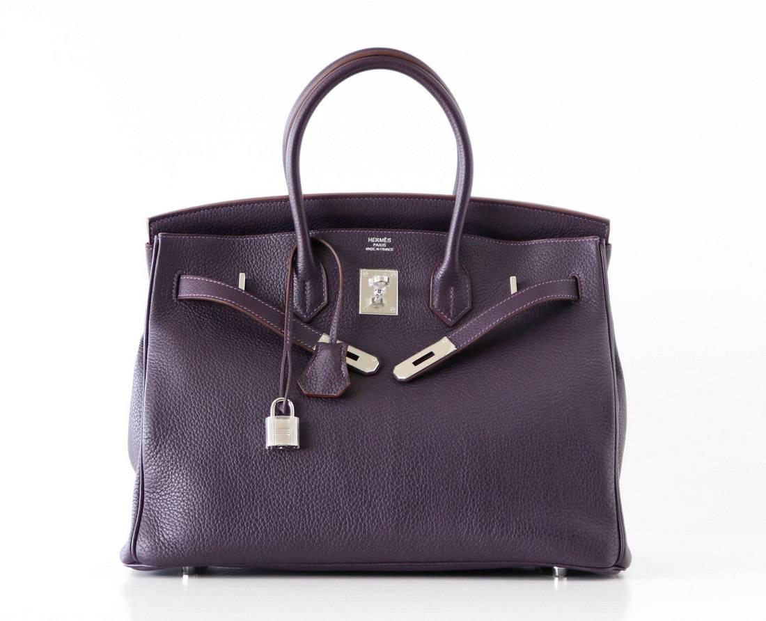 Guaranteed authentic exquisite RAISIN has the richness of a black plum with incredible depth of color.
Palladium hardware still has the protective plastic.
Clemence leather is scratch resistant and buttery soft.
Comes with sleepers, lock, keys,