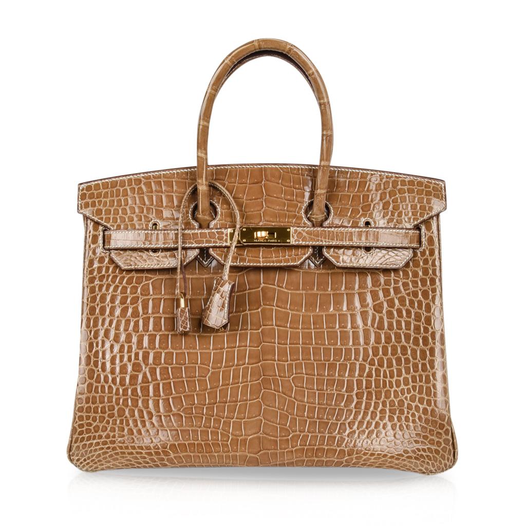 Guaranteed authentic coveted Hermes Birkin 35 bag featured in rare beautiful Ficelle Porosus Crocodile.
Rich with Gold hardware.
The perfect year round neutral.
Comes with lock and keys in the clochette and sleepers.
Bag body, handles, interior are