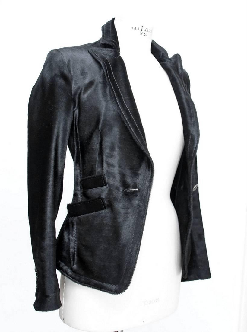 Guaranteed authentic GALLIANO extraordinary glossy jet black pony jacket.  
Superbly shaped with coveted crowned skull rear in black faceted stones.
Jacket has 1 angled breast pocket and 3 angled front pockets.
1 Embossed front button and 4