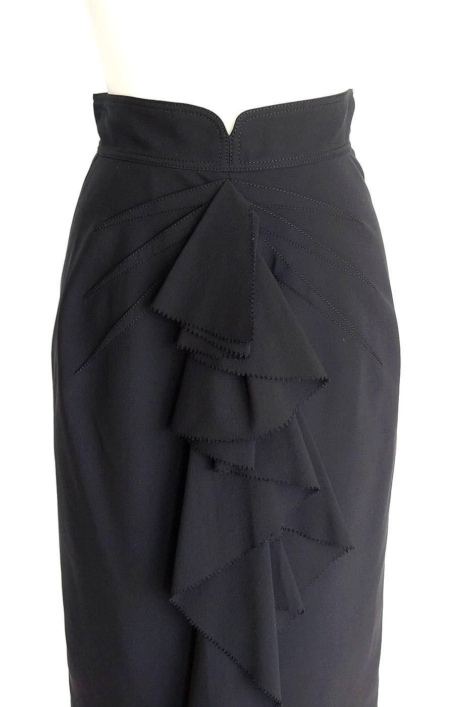 Guaranteed authentic Zac Posen pencil skirt with stitched rouching at top of front and undulating ruffle from waist to hem.
Ruffle has a ric rac edge. Accentuating stitch detail.
Lovely shaped waistband with hidden rear zipper.
Skirt is silk with