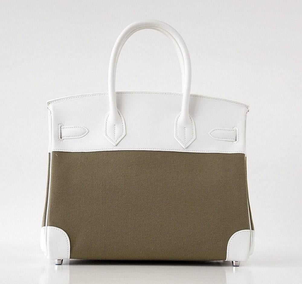 Rare Toile Hermes Birkin 30 bag in rich Olive. 
Beautiful and cool with rare, retired White leather. 
Palladium hardware.
NEW or NEVER WORN
Comes with the lock and keys in the clochette, sleeper for the bag. 
more pictures available upon